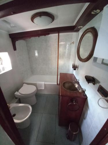 a bathroom with a sink and a toilet and a tub at House Boat Rimini Resort in Rimini