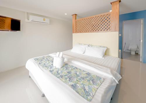 a bedroom with two beds and a toilet at Xanadu Hotel Utapao in Rayong