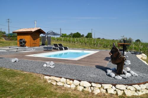 a swimming pool with a statue next to a house at Plaisir d'Eymet du Domaine des Hauts de Rouquette in Eymet