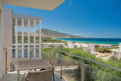 a balcony with a view of the ocean at Bellevue Sardinia Resort Affiliated by Meliá in Valledoria