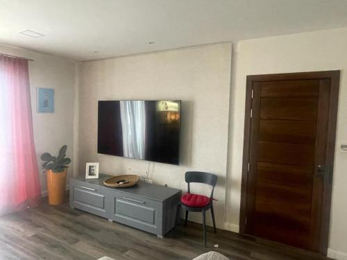 a room with a desk and a tv on the wall at Stylish 2-Bedroom Apartment in Scenic Marsaxlokk in Marsaxlokk