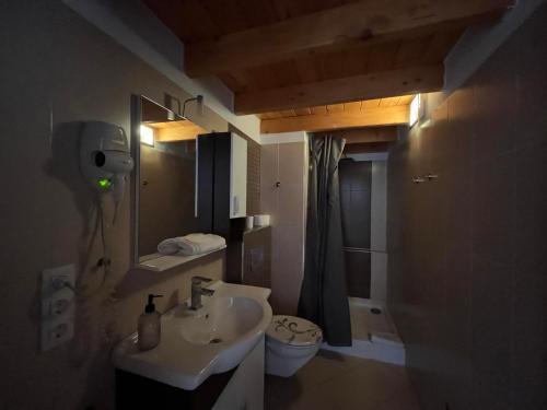 a bathroom with a sink and a toilet at City Apartman ház in Balatonlelle