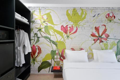 a bedroom with a flower mural on the wall at Airotel Patras Smart Hotel in Patra
