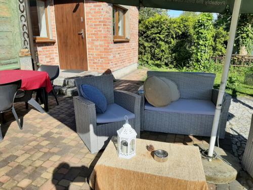 a patio with two chairs and a table and an umbrella at Delfin in Nickelswalde