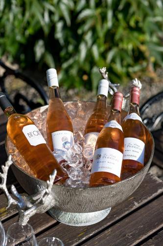 a bowl filled with bottles of wine on a table at Engsholms Slott - Adults Only in Mörkö