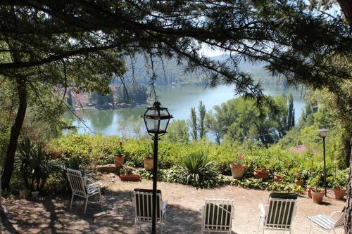 a group of chairs and a street light next to a lake at Villa Orio Lake Piediluco in Piediluco