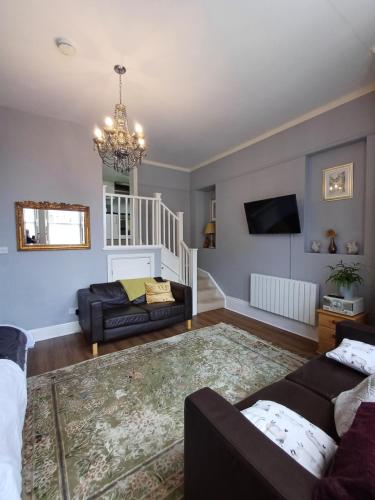 a living room with a couch and a tv at Abbotts Mews Apartment York City Centre in York