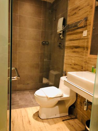 a bathroom with a toilet and a sink and a shower at Kyoto Boutique Hotel in Johor Bahru