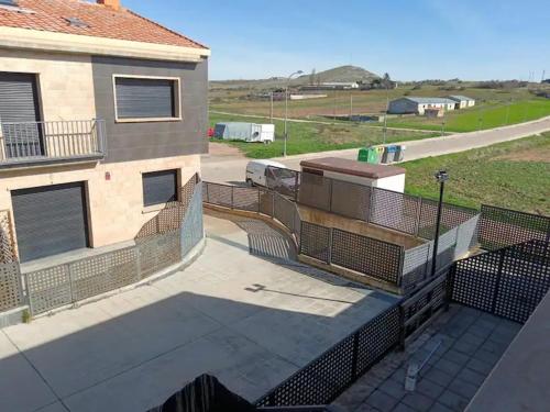a balcony with a fence next to a building at Real 1H in Las Casas