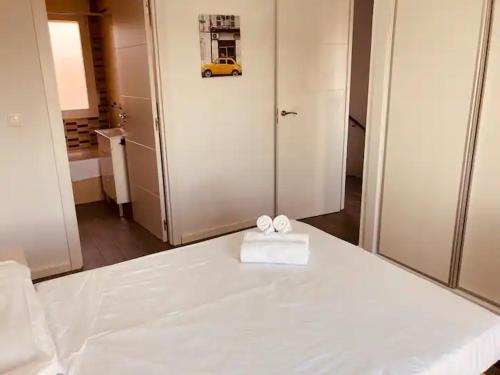 a white bed with a white box on top of it at Real 1H in Las Casas