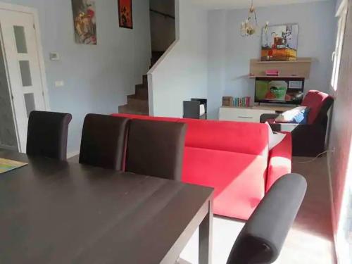 a living room with a red couch and a table at Real 1H in Las Casas