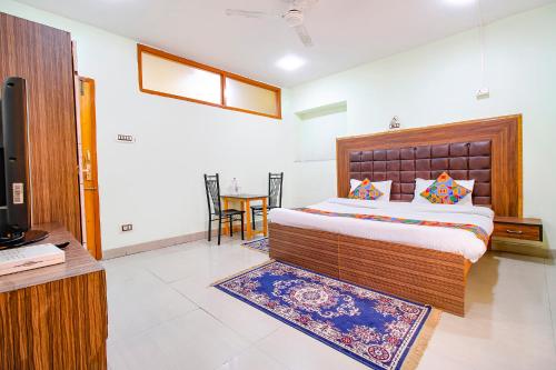 a bedroom with a bed and a tv in a room at FabHotel Grand Comforts in Haidarpur