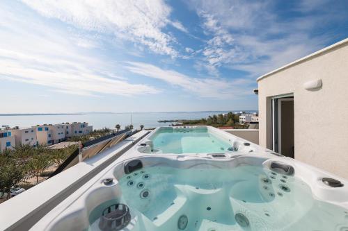 a hot tub on the roof of a building at Villa Miri III in Privlaka