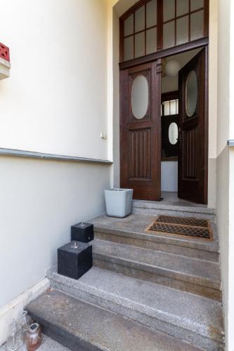 a front door of a building with stairs leading to it at Vila Adelaide in Brtníky