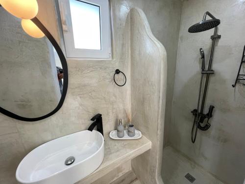 a bathroom with a sink and a mirror at MIRAMAR KARYSTOS in Karistos