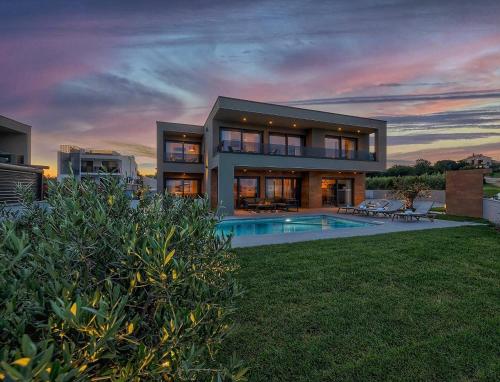 a large house with a swimming pool in the yard at Villa Skalica Pomer - Medulin SEA VIEW in Pomer
