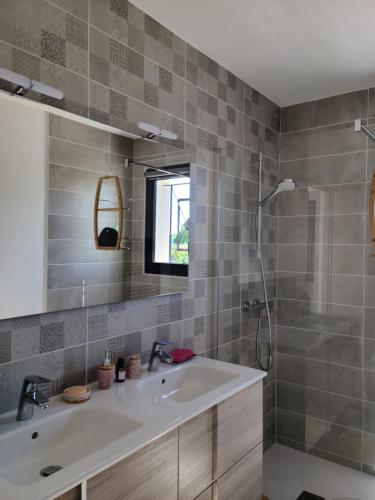 a bathroom with a sink and a shower at Les Papillons d'Uzès in Saint-Laurent-la-Vernède