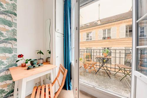 Cette chambre dispose d'un bureau et d'un balcon avec une table. dans l'établissement Petit studio cosy à Saint-Germain-Des-Prés et Jardin du Luxembourg, à Paris