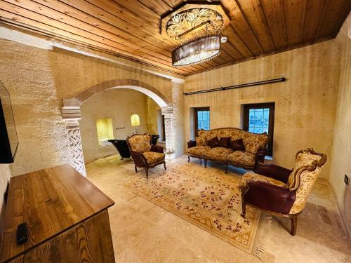a living room with a couch and chairs and a table at Hira Cave Hotel in Goreme