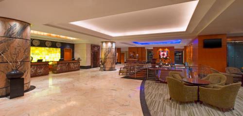 a room with a lobby with a table and chairs at The Westin Dhaka in Dhaka