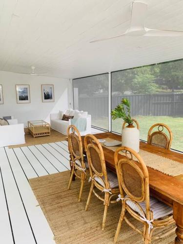 a living room with a wooden table and chairs at Thunder St Cottage Light Bright Home in Bendigo