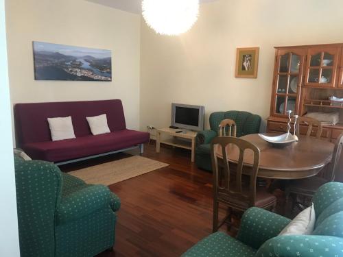 a living room with a table and chairs at Casa da Vila Cerveira in Vila Nova de Cerveira