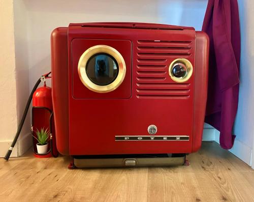 a red suitcase is sitting on a wooden floor at Happy Days On The Lake! in Viverone