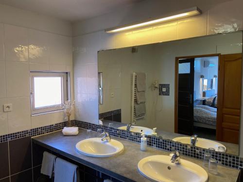 a bathroom with two sinks and a large mirror at Stella Maris in Hyères