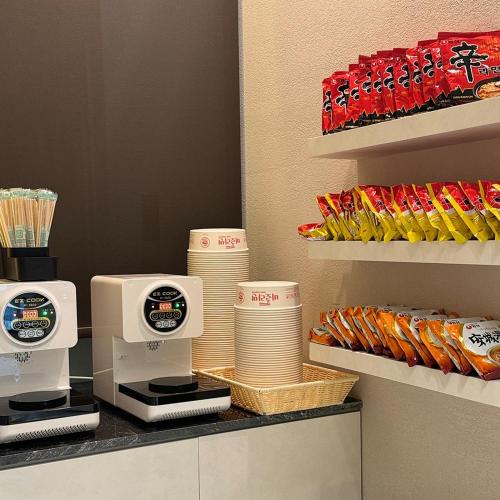 a kitchen counter with a coffee maker and some food at Marysol by Haeundae beach in Busan