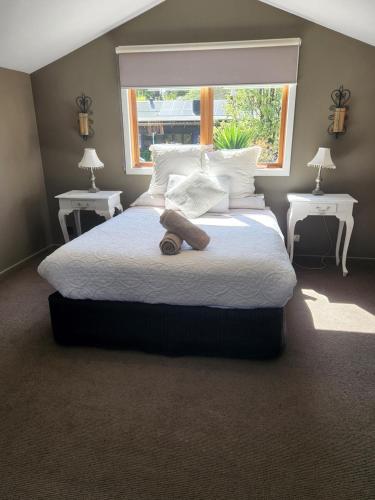 a large bed with a teddy bear laying on it at Montrose Barn House- Entire Home in Montrose