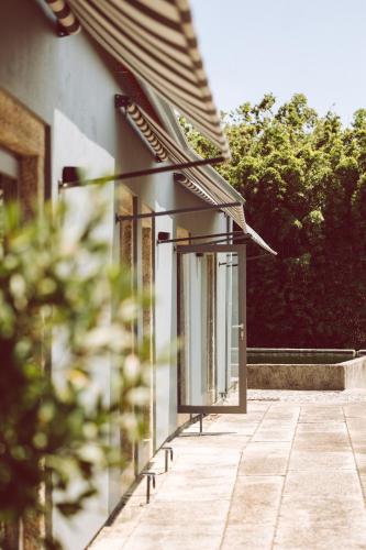 a facade of a building with windows and a sidewalk at Quinta do Monteverde in Viana do Castelo