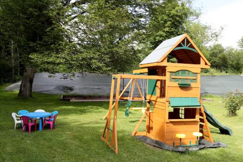 a playground with a play house and a table and chairs at Gîte Au Moulin de Bougnon Calme et Dépaysement en Haute-Saône in Bougnon