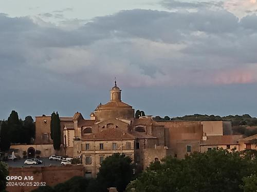 an old building with a cross on top of it at Dea Estia Alloggio Turistico in Tuscania