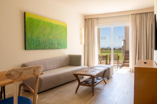 a living room with a couch and a table at Zahara Beach & Spa by QHotels - Adults Recommended in Zahara de los Atunes