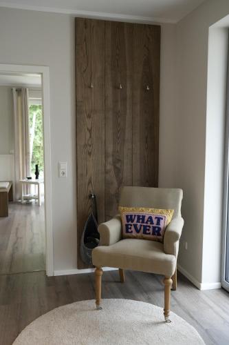 a chair with a pillow on it in a living room at lantliv in Wiesmoor