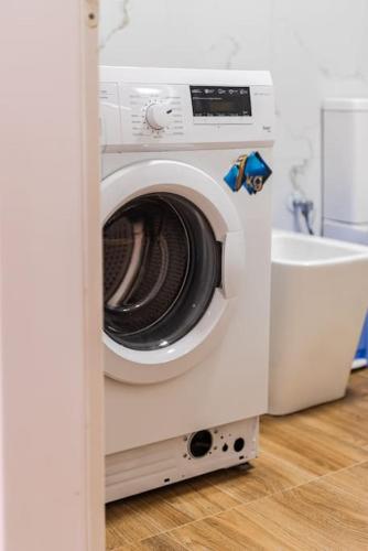 a washing machine in a room with a toilet at Siar The Small Villa in Borsh