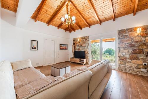 a living room with a couch and a stone wall at Siar The Small Villa in Borsh