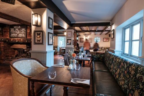 a restaurant with tables and chairs in a room at The Pilgrim Inn in Southampton