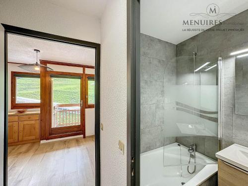 a bathroom with a shower and a tub and a sink at Studio + cabine 4 pers 24m², ski aux pieds, parking à proximité - FR-1-178-106 in Les Menuires