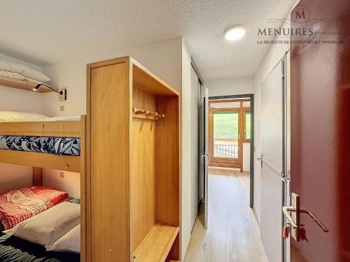 a room with bunk beds and a door to a hallway at Studio + cabine 4 pers 24m², ski aux pieds, parking à proximité - FR-1-178-106 in Les Menuires