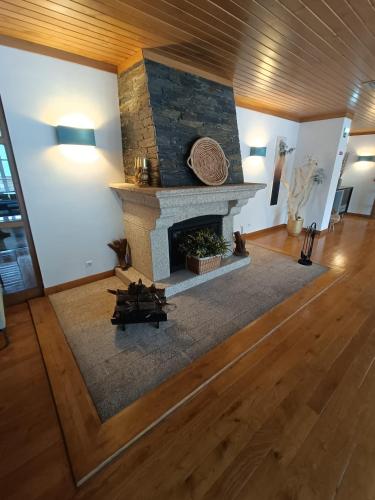 an overhead view of a living room with a stone fireplace at INATEL Piodao in Piódão