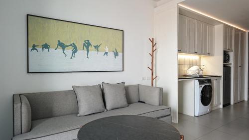 a living room with a couch and a table at Marina House MUAYTHAI Ta-iad Phuket in Chalong 