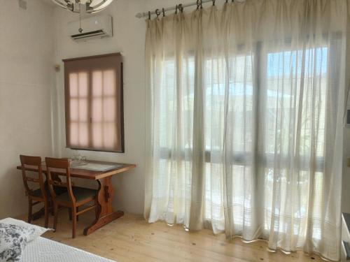 a bedroom with a table and a window with a desk at Simbilis B&B Holiday Experience bouganville in Quartu SantʼElena