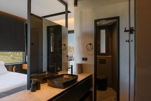 a bathroom with a sink and a large mirror at Māat Villa in Heraklio Town