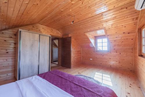 a bedroom with a bed in a wooden room at Panora Oliva in Rap