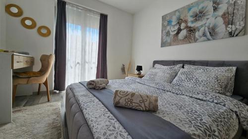 a bedroom with a bed and a large window at Cozy apartment - 2 bedrooms in the best city area. in Ferizaj