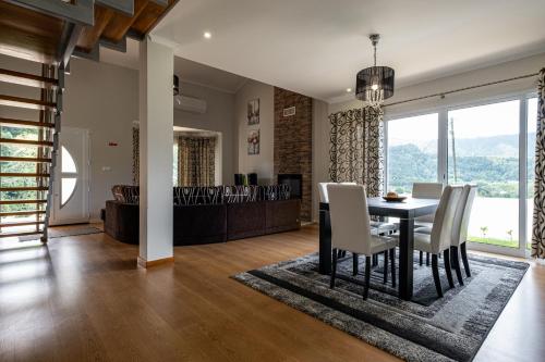 a dining room with a table and chairs with a view at Home In Green Caldera in Furnas