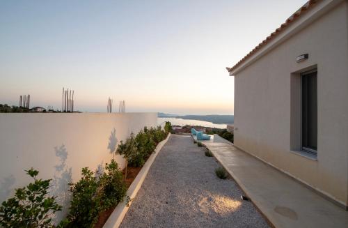 a balcony of a house with a view of the ocean at Sunset Luxury Villa in Akritokhórion