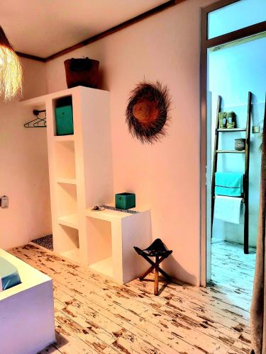 a room with pink walls and a room with a shelf at Mint hause in Nungwi