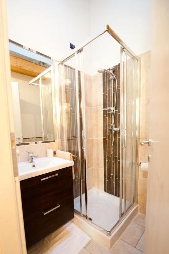 a bathroom with a shower and a sink at Residence La Corte in Vezza dʼOglio